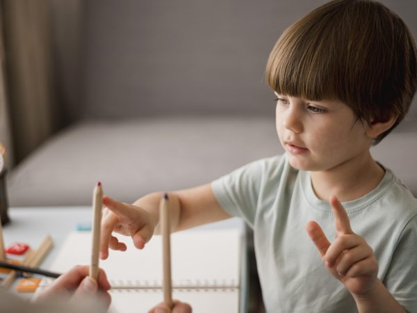 side-view-child-learning-how-count-home-using-pencils